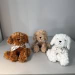Three plush dog toys with ribbon collars on a gray surface