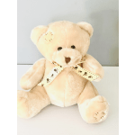 Cream plush teddy bear with a paw-print ribbon