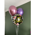 Birthday balloon bouquet with pink and purple balloons and a floral "Happy Birthday" balloon