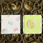 Two decorated square cards with pastel baby-themed designs