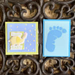 Two baby-themed greeting cards, one with an elephant and one with a footprint