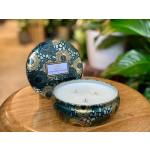 Patterned three-wick candle in a decorative tin