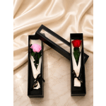 Two single roses in black gift boxes with ribbon ties.