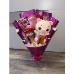 Gift bouquet with a plush pig, heart balloon, and candy bars in pink wrap.