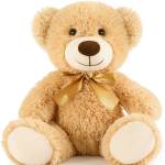Plush teddy bear with a gold ribbon bow