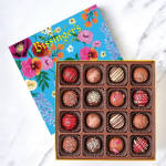 Box of assorted chocolates with a floral-patterned lid