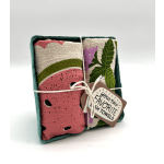 Set of patterned dish towels tied with string in a teal paper tray