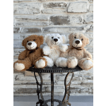 Three teddy bears sitting on a small round metal table