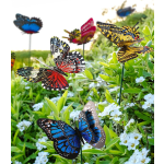 Colorful butterfly garden stakes among green plants and white flowers