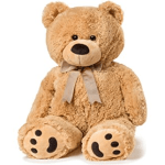 Large tan teddy bear with a ribbon bow