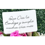 Spanish blessing card clipped above pink and white flowers