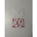 White envelope above a card with pink and peach heart pattern