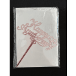Pink "Happy Birthday" cake topper in plastic packaging