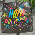 Black birthday balloon with colorful stars and "Happy Birthday" text