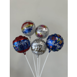 Five birthday balloons on white sticks against a plain wall