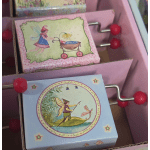 Decorative gift boxes with fairy illustrations in a pink tray