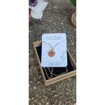 Gold necklace with a floral pendant in a gift box