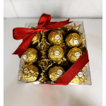 Box of Ferrero Rocher chocolates tied with a red ribbon