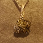 Gold wire pendant with a rough crystal stone on a chain