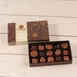 Box of assorted chocolates with the lid behind it