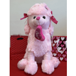 Pink plush teddy bear holding a heart, with gift bags behind it