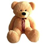 Large tan teddy bear with a ribbon bow