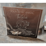A packaged card with a bear illustration and text about a spirit animal.