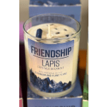 Glass candle labeled Friendship with lapis crystals