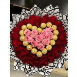 Heart-shaped bouquet of red and pink roses with gold chocolates