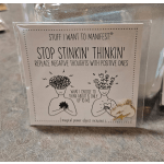 A motivational card in a clear plastic sleeve with a cloud charm