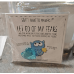 A packaged motivational card with a small blue heart charm