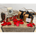 Gift set with candles, rose petals, and a metallic "love" balloon