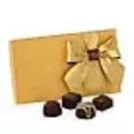 Gift box with a gold ribbon and assorted chocolates