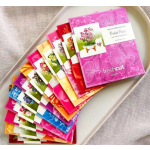Set of colorful floral pop-up greeting cards fanned out on a neutral tray