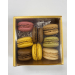 Box of assorted macarons in pink, yellow, brown, and cream