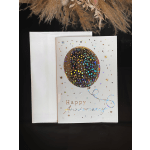 A holographic Happy Anniversary card with a balloon design