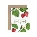 Birthday card with strawberries and green leaves in front of a kraft envelope