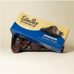 Box and open tray of dark chocolate-covered potato chips on a neutral background