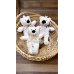 Three small white teddy bears with ribbons arranged in a wicker basket