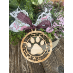 Potted plant with pink-speckled leaves and a wooden paw-print ornament