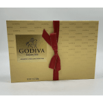 Gold Godiva chocolate gift box with a red ribbon