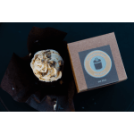 Cupcake in dark wrapping beside a branded bakery box