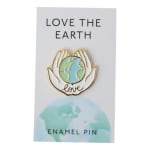 Enamel pin on a card reading "Love the Earth"