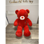 Large red teddy bear with a heart-shaped "I love you" tag