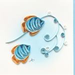 Paper quilling artwork of two blue fish with orange accents