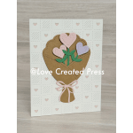 Paper card with a heart-shaped bouquet illustration and pink ribbon