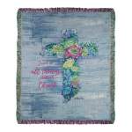 Religious throw blanket with floral cross design and inspirational text on a blue wood-look background