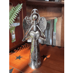 Silver angel figurine with heart-shaped hands on a wooden surface