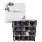 Box of assorted chocolates with a white gift box and ribbon