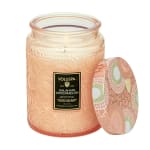 Peach glass candle jar with a patterned lid